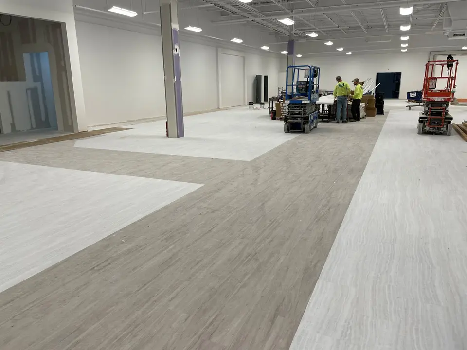 Crew and lifts on a retail floor install at TJ Maxx, Salem NH